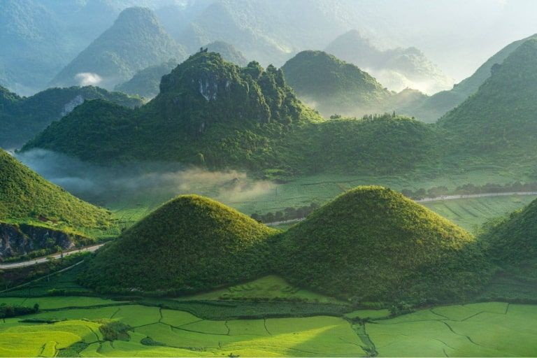 The Twin Mountains of Quan Ba - In April's gentle light, these iconic "Fairy Breast" peaks stand side-by-side amidst lush green fields