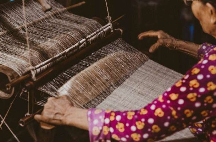 A Hmong artisan hand-weaves traditional linen fabric at the Lung Tam Weaving Village in Ha Giang, Vietnam
